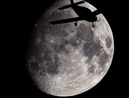 A Piper Warrior Airplane flying in front of the Moon